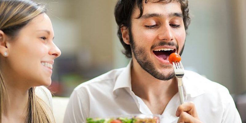 Young man eating a salad